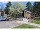 Exterior view of the building featuring stone accents and a well-maintained landscape at 2575 S Syracuse Way # H206, Denver, CO 80231