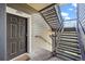Apartment entry with gray door, unit number, and exterior staircase at 2575 S Syracuse Way # H206, Denver, CO 80231