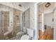 A bathroom with a glass enclosed shower and decorative wallpaper at 1284 N Corona St # B6, Denver, CO 80218