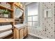 A well decorated bathroom with geometric wallpaper, mosaic tile, and shelving at 1284 N Corona St # B6, Denver, CO 80218