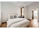 A sunny bedroom with hardwood floors, fan, and comfortable bed near a window at 1284 N Corona St # B6, Denver, CO 80218