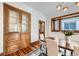 Charming dining room featuring a china cabinet, hardwood floors, and bright natural light, perfect for Gathering gatherings at 1284 N Corona St # B6, Denver, CO 80218