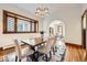 Well-lit dining area showcases a wooden table with seating for six, complemented by hardwood floors and classic windows at 1284 N Corona St # B6, Denver, CO 80218