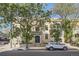 Elegant brick apartment building showcases mature trees and a well-maintained facade, reflecting timeless charm and appeal at 1284 N Corona St # B6, Denver, CO 80218