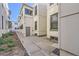 Exterior side view of a property featuring white painted brick and concrete pathway at 1284 N Corona St # B6, Denver, CO 80218