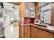 Charming kitchen nook featuring wooden cabinets, marble countertops, window and view to the kitchen at 1284 N Corona St # B6, Denver, CO 80218