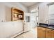 A laundry room featuring natural light and built-in shelving and cabinets at 1284 N Corona St # B6, Denver, CO 80218
