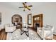 Charming living room showcasing a classic fireplace, neutral furniture, and seamless flow into an adjacent dining area at 1284 N Corona St # B6, Denver, CO 80218