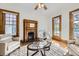Relaxing living room featuring a brick fireplace, plush armchairs, and an inviting space with balcony access and natural light at 1284 N Corona St # B6, Denver, CO 80218