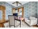 Well-lit office showcasing patterned wallpaper, hardwood floors, a wooden doorframe and large window that provides ample natural light at 1284 N Corona St # B6, Denver, CO 80218