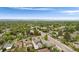 Scenic aerial view of a residential neighborhood with lush trees, streets, and houses under a blue sky at 3176 Depew St, Wheat Ridge, CO 80214