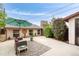 Inviting backyard patio with stylish seating, umbrella, concrete, and decorative elements for outdoor relaxation at 3176 Depew St, Wheat Ridge, CO 80214