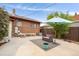 Comfortable backyard with stylish seating, umbrella, concrete, and privacy fence at 3176 Depew St, Wheat Ridge, CO 80214