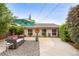 Inviting backyard patio with stylish seating, umbrella, concrete, and decorative elements for outdoor relaxation at 3176 Depew St, Wheat Ridge, CO 80214
