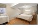 Cozy bedroom featuring hardwood floors, natural light, and a comfortable bed at 3176 Depew St, Wheat Ridge, CO 80214