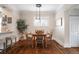 Cozy dining room features a wooden table set, accent lighting, hardwood floors and a breakfast bar area at 3176 Depew St, Wheat Ridge, CO 80214