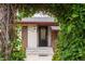 Charming front entrance framed by lush greenery, highlighting the door and brick facade at 3176 Depew St, Wheat Ridge, CO 80214