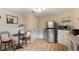 Eat in kitchen with stainless steel appliances, light wood floors, and breakfast table at 3176 Depew St, Wheat Ridge, CO 80214