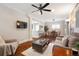 Open-concept living room with breakfast bar, dining area, hardwood floors, and modern lighting at 3176 Depew St, Wheat Ridge, CO 80214