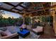 Relax on this spacious deck featuring comfortable seating and views of the private backyard and open space at 25779 E Jamison Cir, Aurora, CO 80016