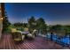 Open deck showcases ample seating, dining and stunning views of the yard, pool and open space beyond at 25779 E Jamison Cir, Aurora, CO 80016