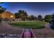 Spacious backyard with a volleyball net, mature trees, and a view of the house at 25779 E Jamison Cir, Aurora, CO 80016