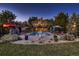 This home features an in-ground pool, spa, outdoor kitchen, lush landscaping and an expansive lawn at 25779 E Jamison Cir, Aurora, CO 80016