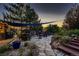 Stone patio offers a cozy outdoor seating area, string lights, colorful flowers, and open views at 25779 E Jamison Cir, Aurora, CO 80016