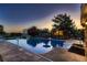 This backyard oasis features a pool, a full outdoor kitchen, a slide, and a diving board at 25779 E Jamison Cir, Aurora, CO 80016