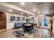 Finished basement with a cozy seating area, round table, and sliding doors to the pool area at 25779 E Jamison Cir, Aurora, CO 80016