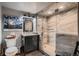 Bathroom features a glass enclosed shower with marble tile and a modern vanity at 25779 E Jamison Cir, Aurora, CO 80016