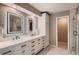 Contemporary bathroom featuring a double vanity, backlit mirrors, and a separate glass shower at 25779 E Jamison Cir, Aurora, CO 80016