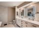 Stylish bathroom with double vanity sinks, illuminated mirrors, and modern fixtures at 25779 E Jamison Cir, Aurora, CO 80016
