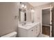 Bright bathroom featuring a double vanity with white cabinets, and neutral walls at 25779 E Jamison Cir, Aurora, CO 80016