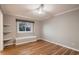 Bedroom with hardwood floors, a built-in bench, and open shelving at 25779 E Jamison Cir, Aurora, CO 80016
