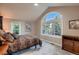 Serene bedroom with large windows showcasing tree views, complemented by neutral tones and comfortable furnishings at 25779 E Jamison Cir, Aurora, CO 80016
