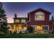 Charming home featuring a covered porch, well-manicured lawn, and a mix of siding and stone accents at 25779 E Jamison Cir, Aurora, CO 80016