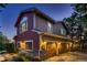 Spacious three-car garage with beautiful wood doors, stone accents and well-maintained landscaping at 25779 E Jamison Cir, Aurora, CO 80016
