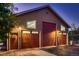 Spacious three-car garage with three bays, a side entry door, and exterior lighting at 25779 E Jamison Cir, Aurora, CO 80016