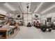 Well-lit and spacious garage interior with ample storage, work areas, and overhead lighting at 25779 E Jamison Cir, Aurora, CO 80016