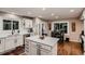 Bright kitchen with white cabinets, stainless steel appliances, a large island and hardwood floors at 25779 E Jamison Cir, Aurora, CO 80016