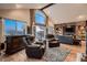 Bright living room featuring a wet bar, two recliners, hardwood floors, and outdoor views at 25779 E Jamison Cir, Aurora, CO 80016