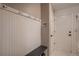 Mudroom with a bench, coat hooks, storage, and a light-colored tile floor at 25779 E Jamison Cir, Aurora, CO 80016