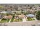 A bird's eye view of the home highlighting its location and its proximity to other homes and mature trees at 6905 Nelson St, Arvada, CO 80004