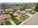An aerial view shows the home's solar panels, lawn and beautiful landscaping in a suburban setting at 6905 Nelson St, Arvada, CO 80004