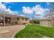 Green backyard, a shed, and a covered patio at 6905 Nelson St, Arvada, CO 80004