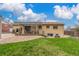 Backyard with patio, pergola, and well-maintained lawn at 6905 Nelson St, Arvada, CO 80004