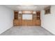Spacious basement featuring custom built-in shelving and soft carpet at 6905 Nelson St, Arvada, CO 80004
