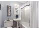 Clean bathroom featuring a pedestal sink, toilet, bathtub and vanity mirror at 6905 Nelson St, Arvada, CO 80004