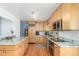 Modern kitchen featuring stainless steel appliances, granite countertops, and wood cabinetry at 6905 Nelson St, Arvada, CO 80004
